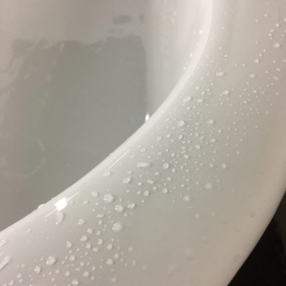 beads of water on a clawfoot bathtub's finish, sanded and polished to a mirror-like reflection by Joy of St Croix,