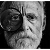 A black and white photo of a person holding a magnifying glass to their left eye, is used as a visual support to the exhortation, "When identifying a bathtub repair for estimating, take a close look at all of the damage, not just your immediate impression."