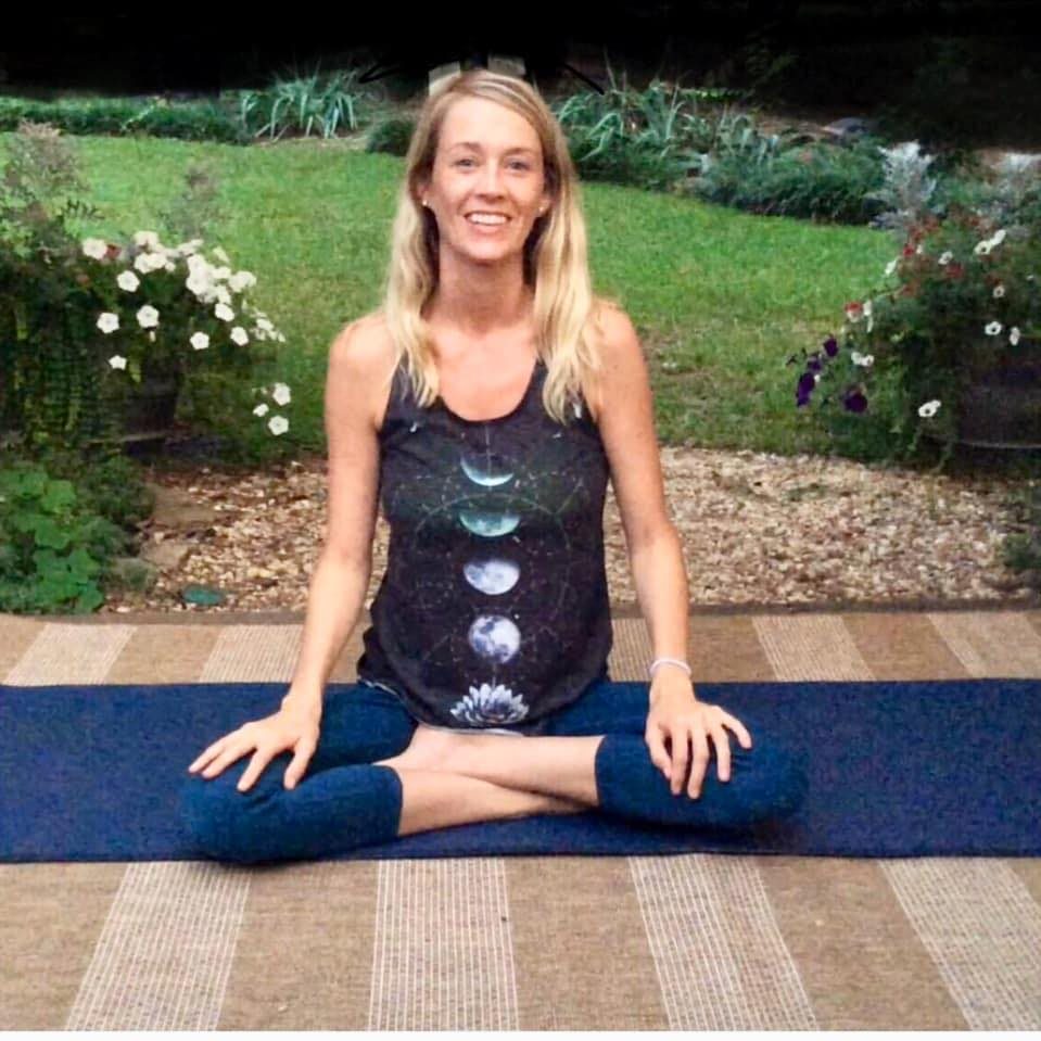 picture of Kelley Harvey sitting on a yoga mat