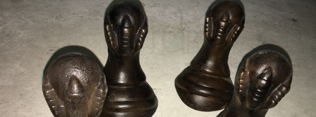 4 unattached cast iron eagle's feet clutching a sphere from a vintage or antique cast iron clawfoot bathtub